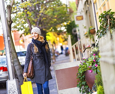 Portrait of blond woman walking on sidewalk, USA, New York City, Brooklyn, Williamsburg