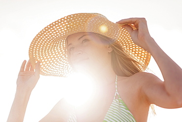 Young woman in sun hat on beach