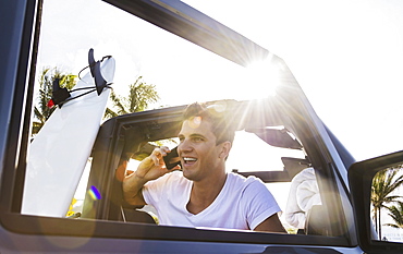 Young man using mobile phone, Jupiter, Florida, USA