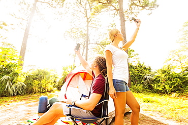 Couple looking for range on cell phone, Tequesta, Florida