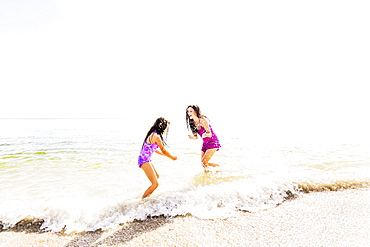 Girl (6-7) and her mom enjoying themselves on beach, Jupiter, Florida