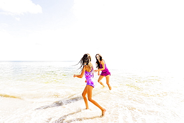 Girl (6-7) and her mom enjoying themselves on beach, Jupiter, Florida