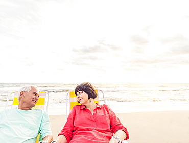 Older couple relaxing on beach, Jupiter, Florida