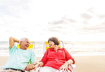 Older couple relaxing on beach, Jupiter, Florida