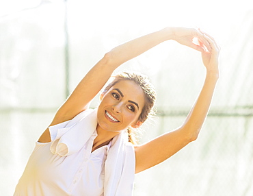 Portrait of young woman stretching