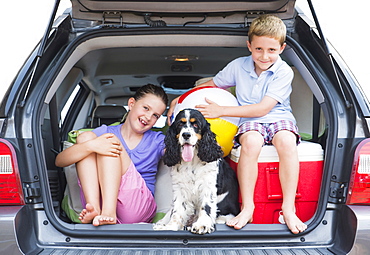 Girl (8-9) together with her brother (6-7) and their do setting out for vacations