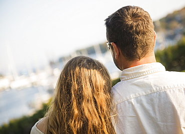Back view of couple looking at harbor, Camden, Maine
