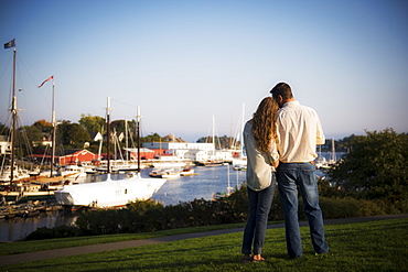 Back view of couple looking at harbor, Camden, Maine