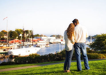 Back view of couple looking at harbor, Camden, Maine
