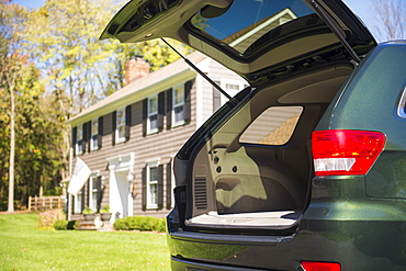 Open car trunk in front of house, Mendham, New Jersey