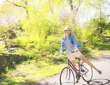 Mid adult woman riding bicycle, Central Park, New York City