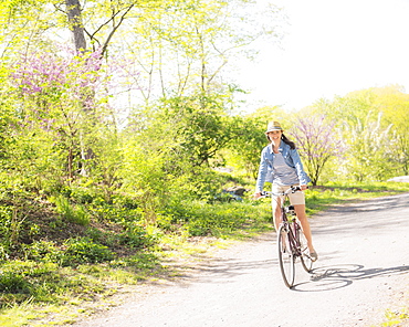 Mid adult woman riding bicycle, Central Park, New York City