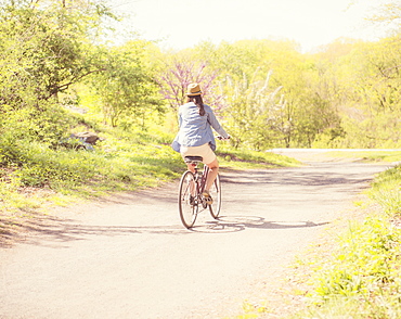 Mid adult woman riding bicycle, Central Park, New York City