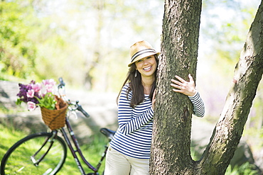 Portrait of mid adult woman embracing tree, Central Park, New York City