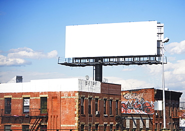 Blank billboard over urban buildings