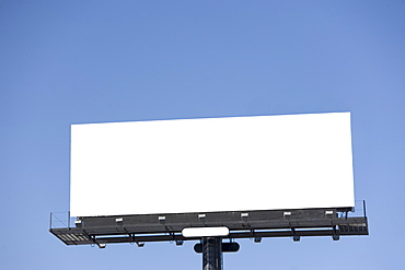 Blank billboard under blue sky