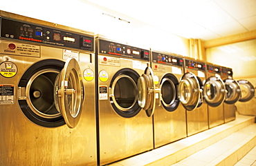 Row of washing machines in laundromat