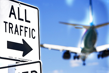 All traffic sign and airplane in background