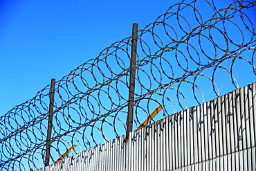 Low angle view of barbed wire fence