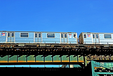 Elevated train under blue sky