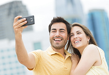 Couple taking self portrait photo with smartphone