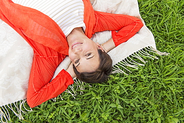 Mature woman lying on grass