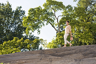 Mature woman walking on rock