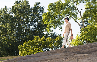 Mature woman walking on rock