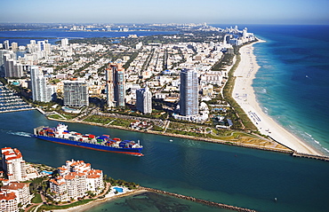 Aerial view of waterfront city and cargo ship