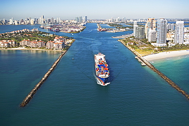 Aerial view of waterfront city and cargo ship