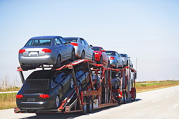 Truck carrying new cars