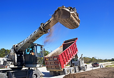 Dump truck and loader on construction site