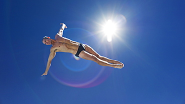 Athletic swimmer jumping