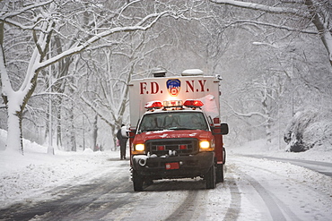 New York City fire department vehicle driving on snowy road