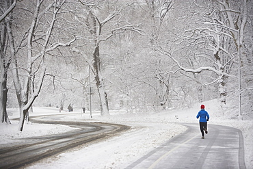 Jogger on snowy road