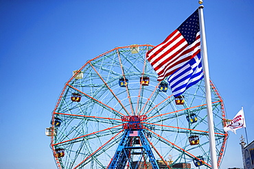 Flags in front of Ferris wheel