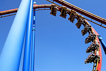 Rollercoaster against blue sky