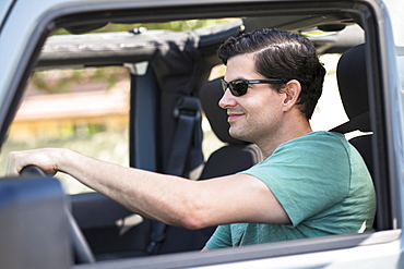 View of man driving car