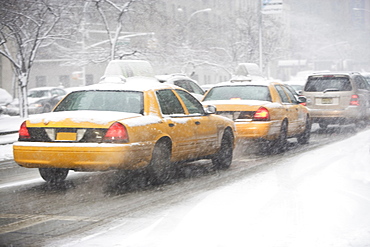 USA, New York City, yellow cabs on snowy street