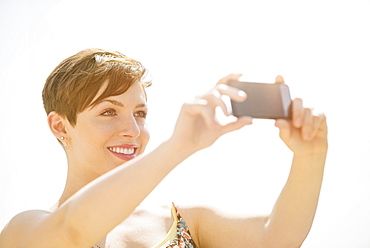 Young woman taking selfie with mobile phone