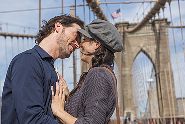 Happy couple kissing on Brooklyn Bridge, Brooklyn, New York