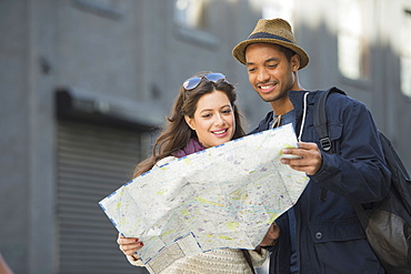 Couple reading map on street