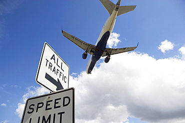 Airplane flying above road signs