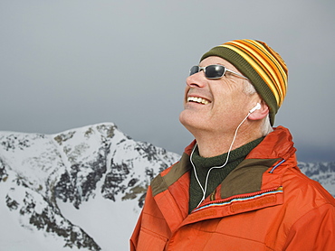 Man wearing earbuds in mountains