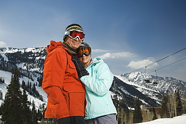 Couple in ski gear hugging