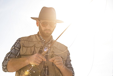 Portrait of man holding fishing rod