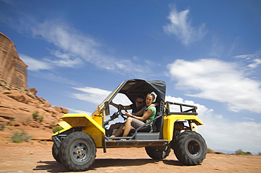 Woman driving off-road vehicle in desert