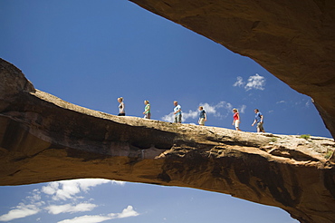 People walking on rock formation