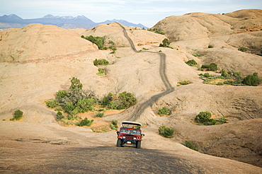 Off-road vehicle driving on rock formation