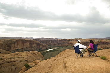 Couple in camping chairs over-looking canyon